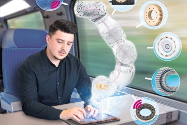 Человек с планшета управляет роботом-манипулятором